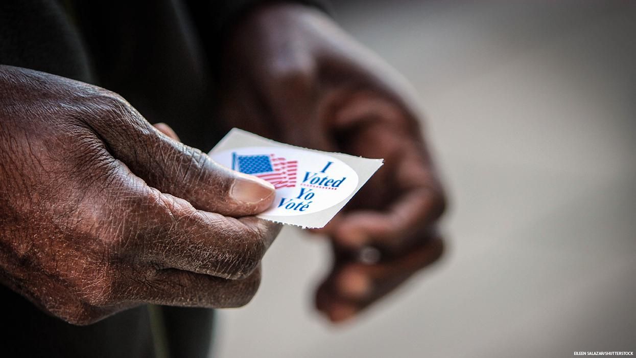 Elderly Black hands holding I Voted sticker