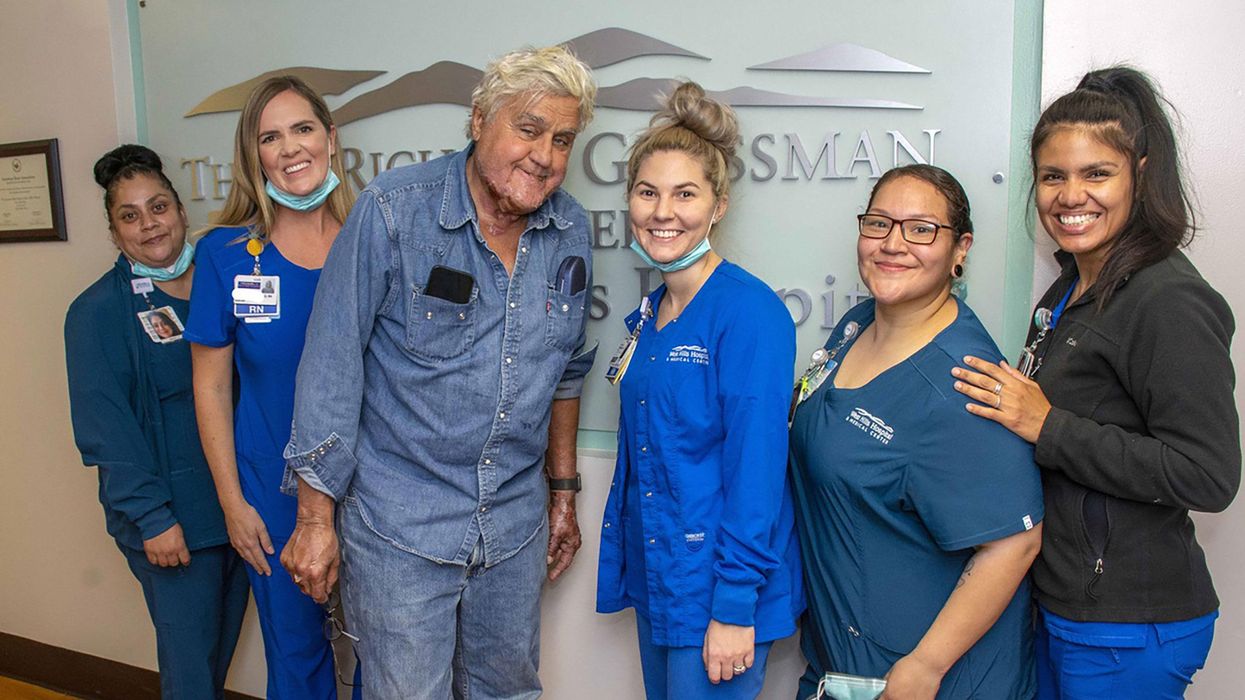 	Jay Leno has been discharged from the hospital after sustaining burn injuries in a gasoline fire. Leno is seen here with the staff of the Grossman Burn Center on November 21.