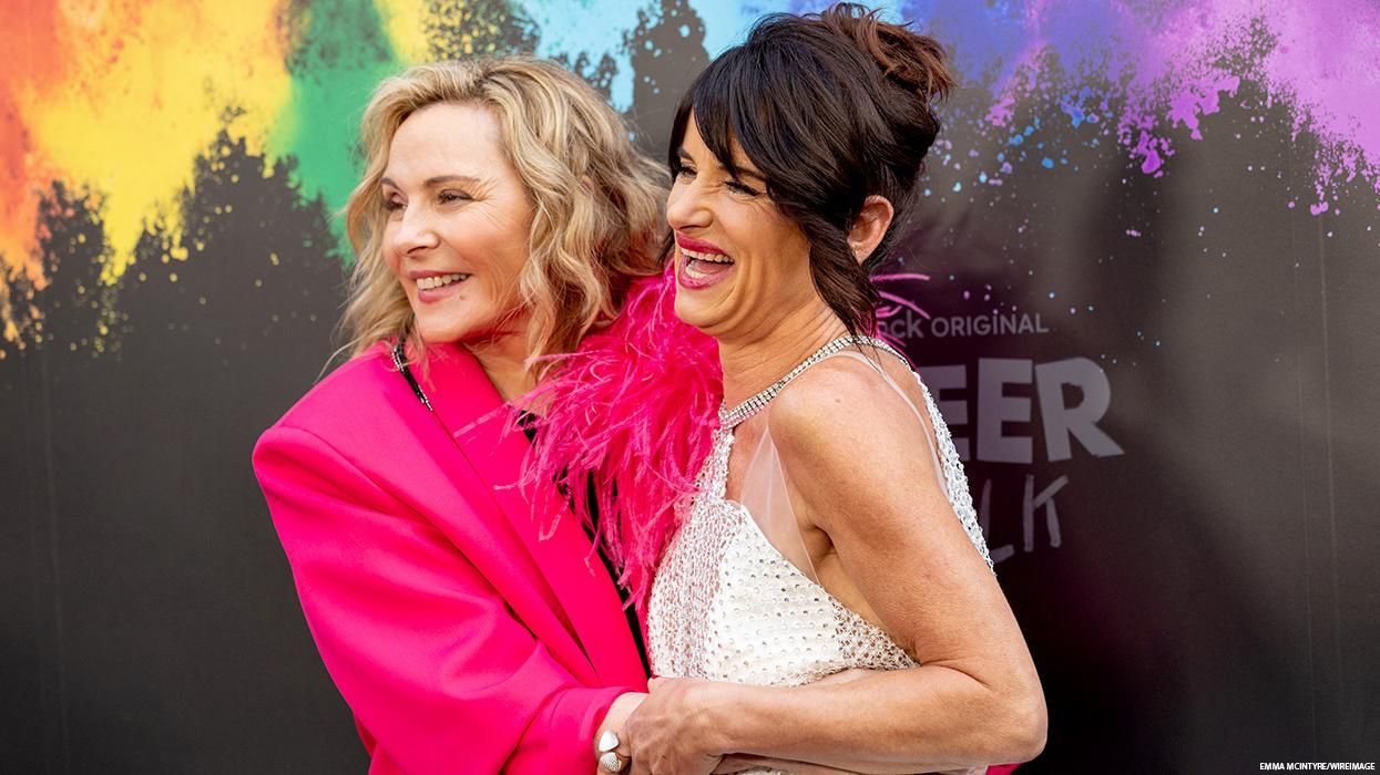 Kim Cattrall and Juliette Lewis embrace at an event.
