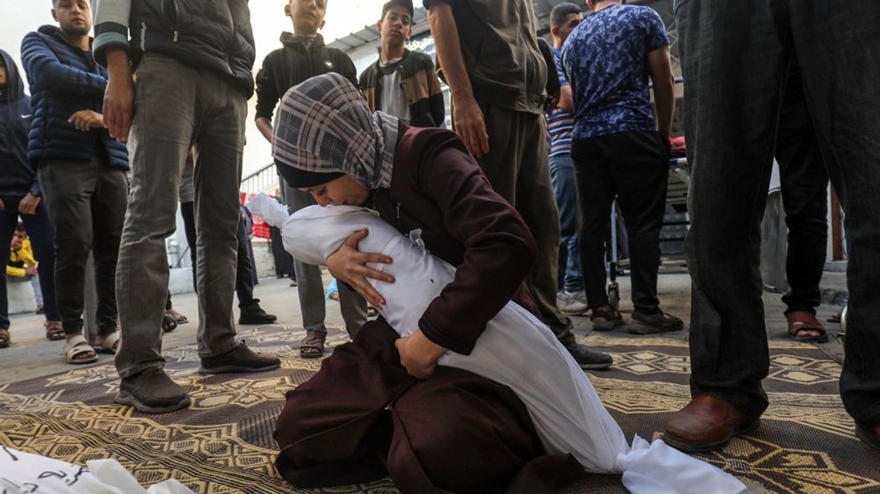 Palestinian mother cradles body of child killed in Israeli airstrike
