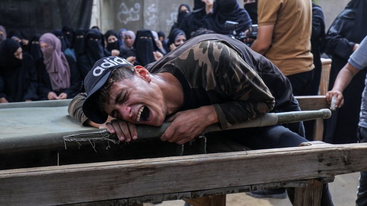 Palestinians mourn the body of a young man
