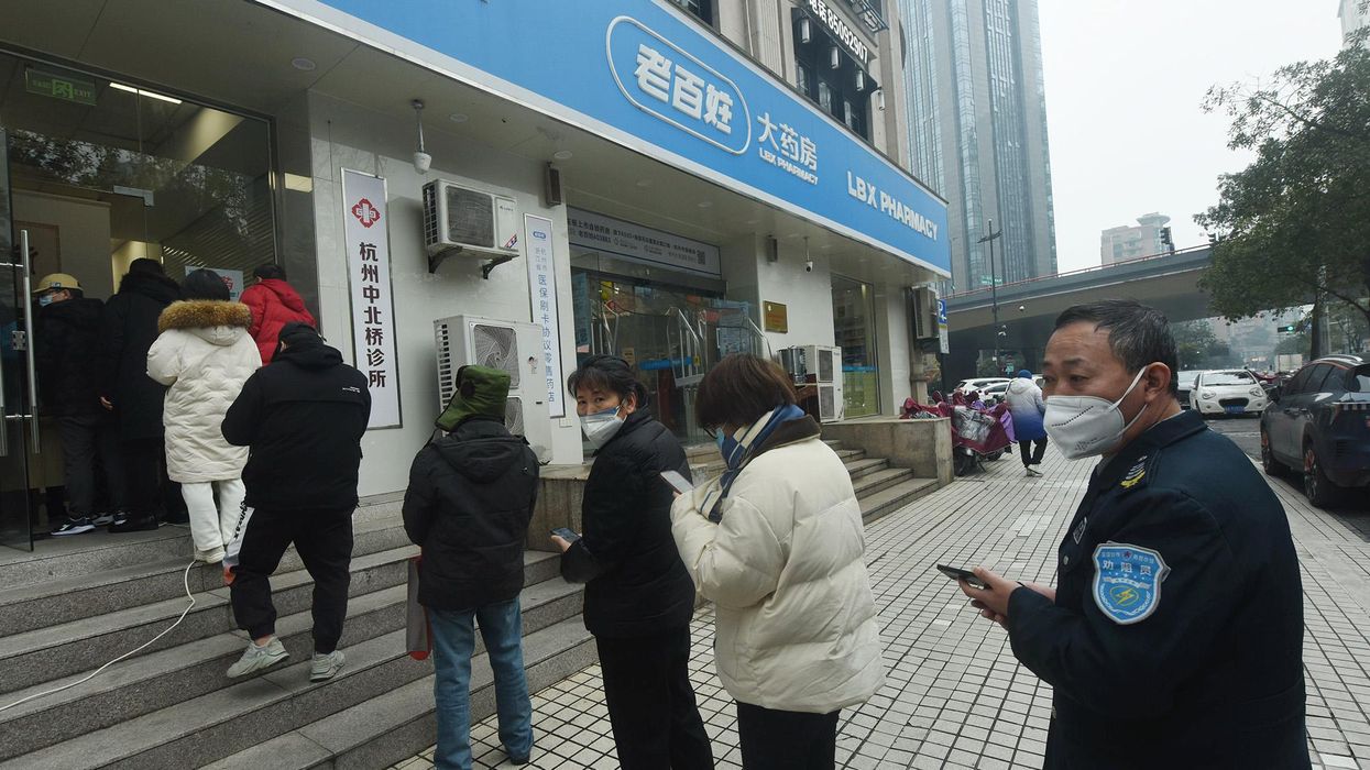 People wait in line at the pharmacy in China.